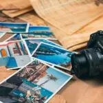 A collection of travel photos alongside a Canon camera, symbolizing adventure and creativity.